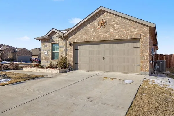 a view of a house with a wooden fence