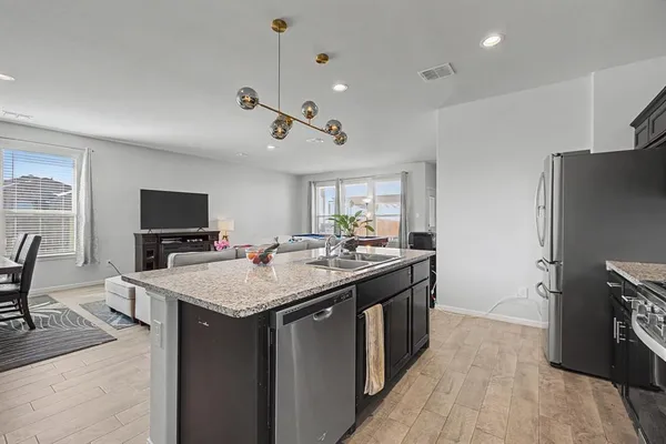 a kitchen with a stove and a refrigerator