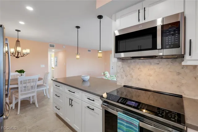 a kitchen with a sink stainless steel appliances and cabinets
