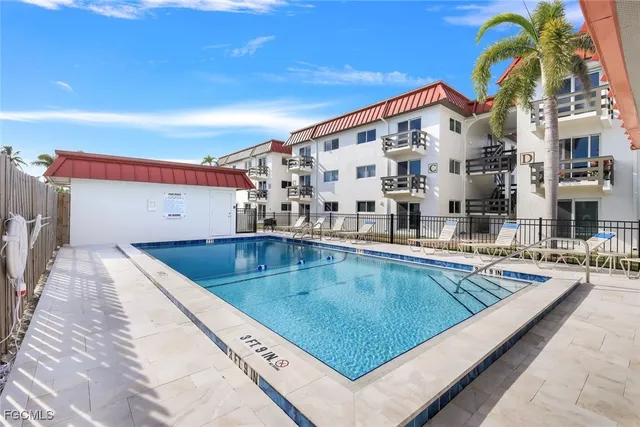 a view of swimming pool with outdoor seating