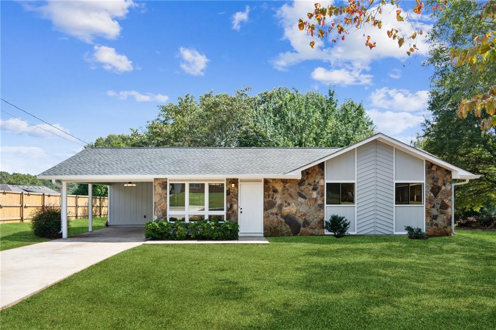 a front view of house with yard and green space