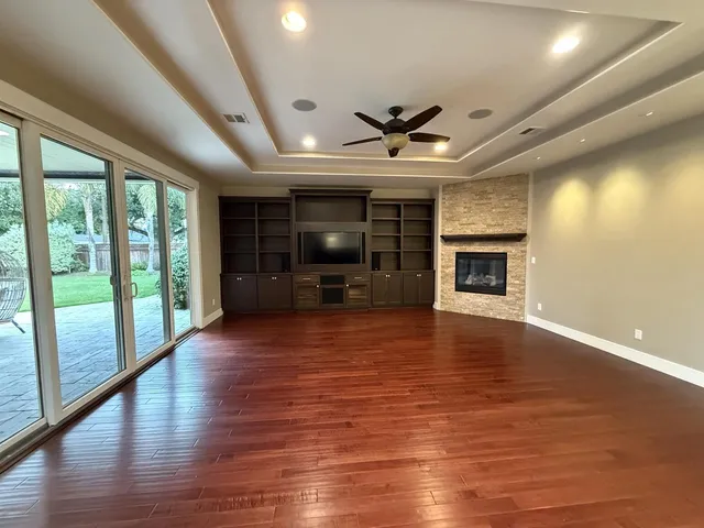 wooden floor in an empty room with a fireplace