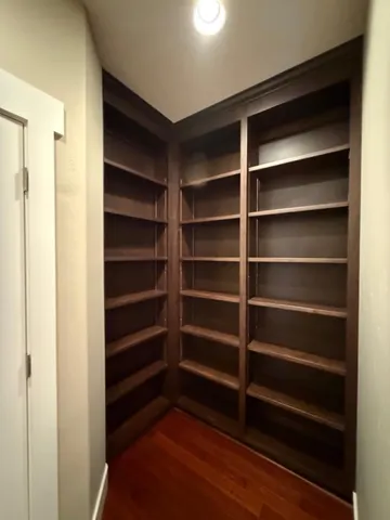 a view of walk in closet with empty racks