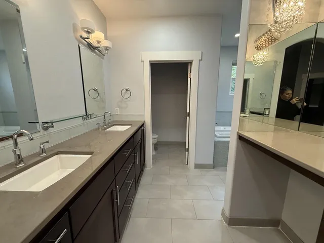 a bathroom with a double vanity sink a and a mirror