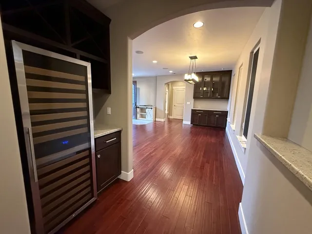 a view of a hallway view with wooden floor and staircase