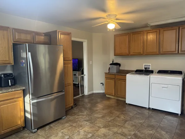 a kitchen with cabinets and stainless steel appliances