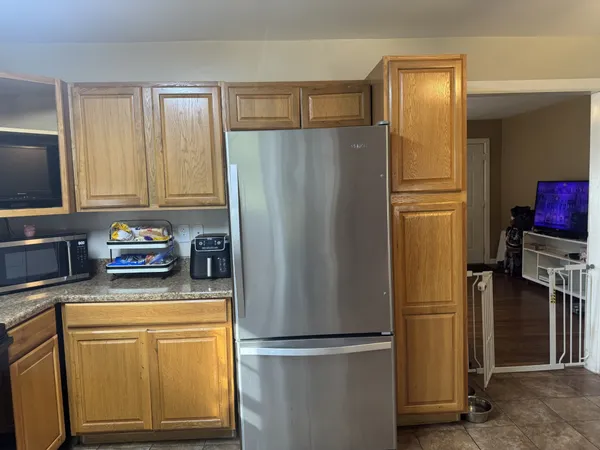 a kitchen with stainless steel appliances granite countertop a refrigerator and a stove