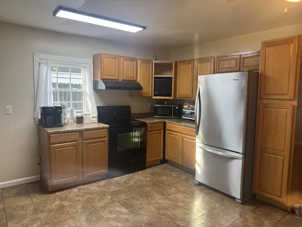 a kitchen with a refrigerator stove and sink
