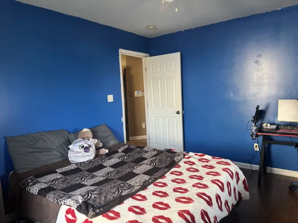 a bedroom with a bed and a lamp on table