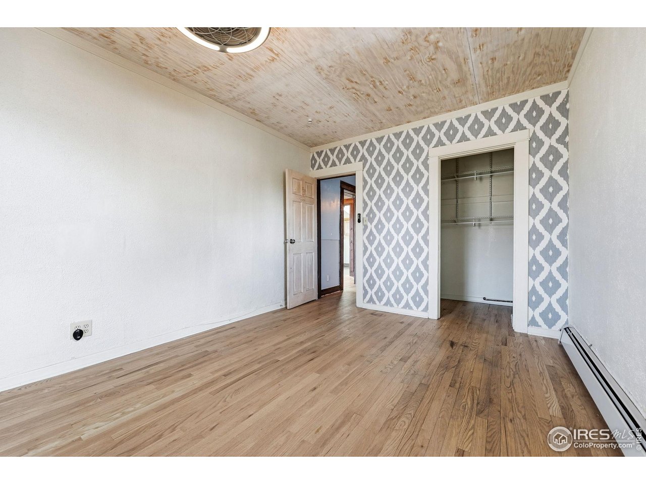 4635 Teller Street Wheat Ridge, CO 80033 - Photo 20 of 36 a view of an empty room with wooden floor