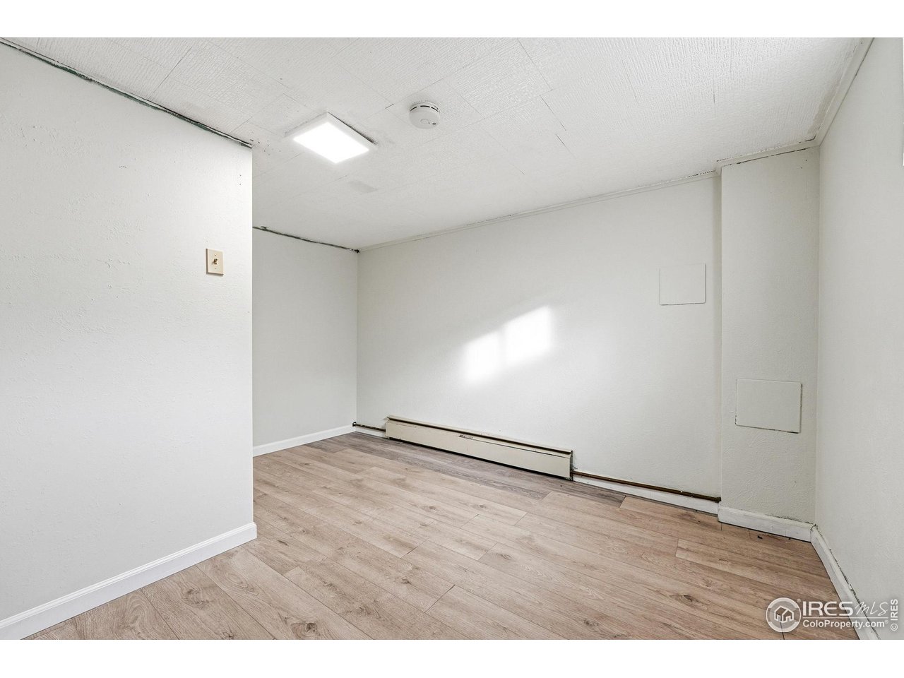 4635 Teller Street Wheat Ridge, CO 80033 - Photo 26 of 36 a view of an empty room with wooden floor