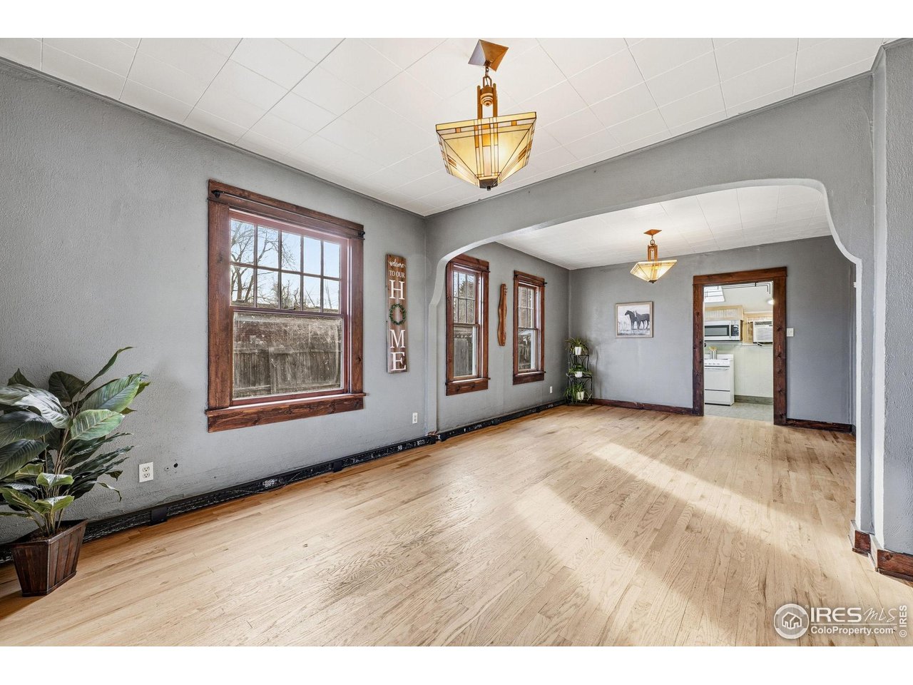 4635 Teller Street Wheat Ridge, CO 80033 - Photo 8 of 36 a view of an empty room with a window and wooden floor