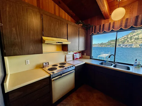a kitchen with stainless steel appliances a sink a stove and a microwave