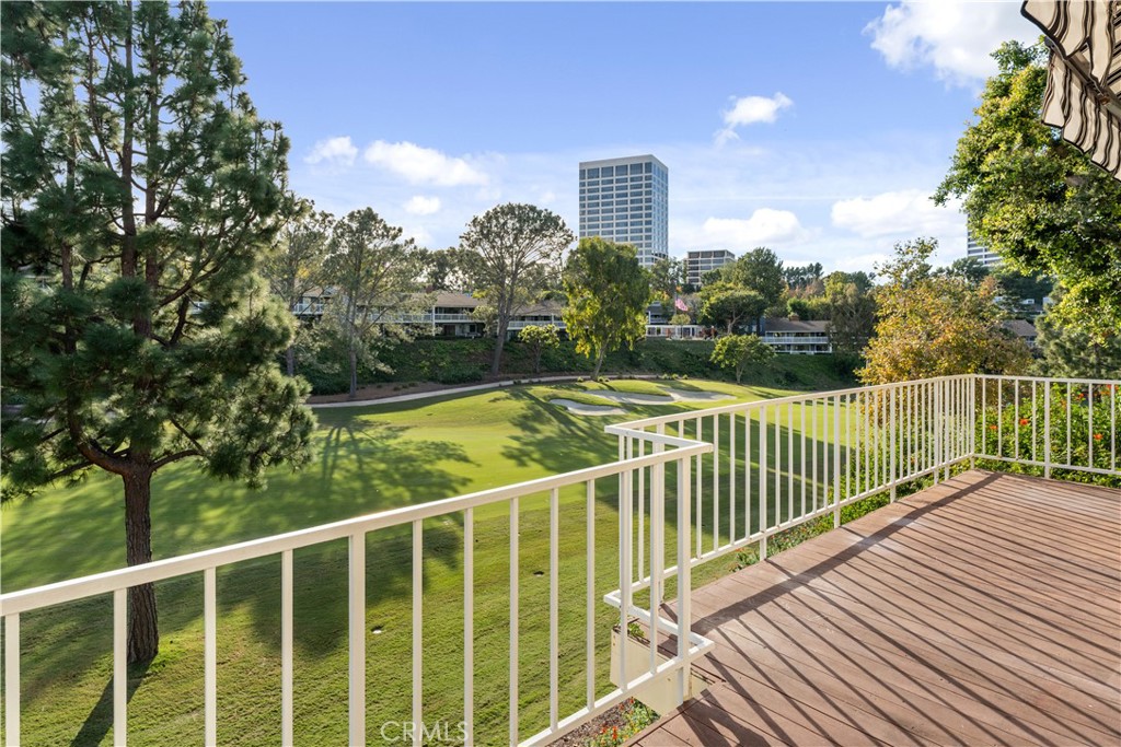 1 Rue Du Parc Newport Beach, CA 92660 - Photo 2 of 49 a view of a balcony with floor to ceiling windows and wooden fence