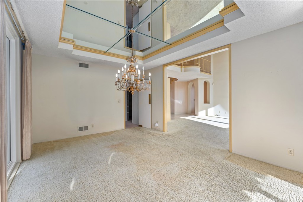 1 Rue Du Parc Newport Beach, CA 92660 - Photo 28 of 49 an empty room with a chandelier fan and windows