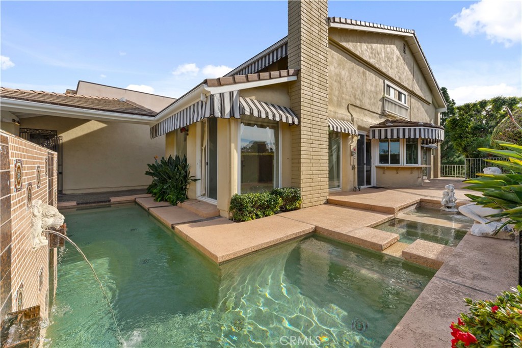 1 Rue Du Parc Newport Beach, CA 92660 - Photo 4 of 49 a view of house with swimming pool and porch
