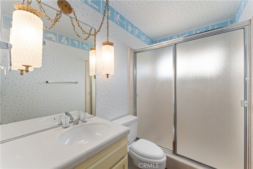 1 Rue Du Parc Newport Beach, CA 92660 - Photo 42 of 49 a bathroom with a sink and mirror with toilet