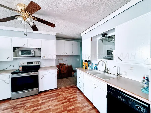 a kitchen with stainless steel appliances a sink stove and refrigerator