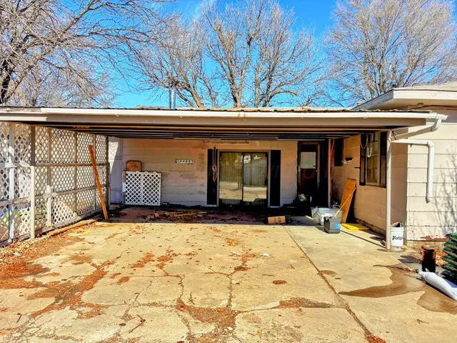 a view of garage with a large tree