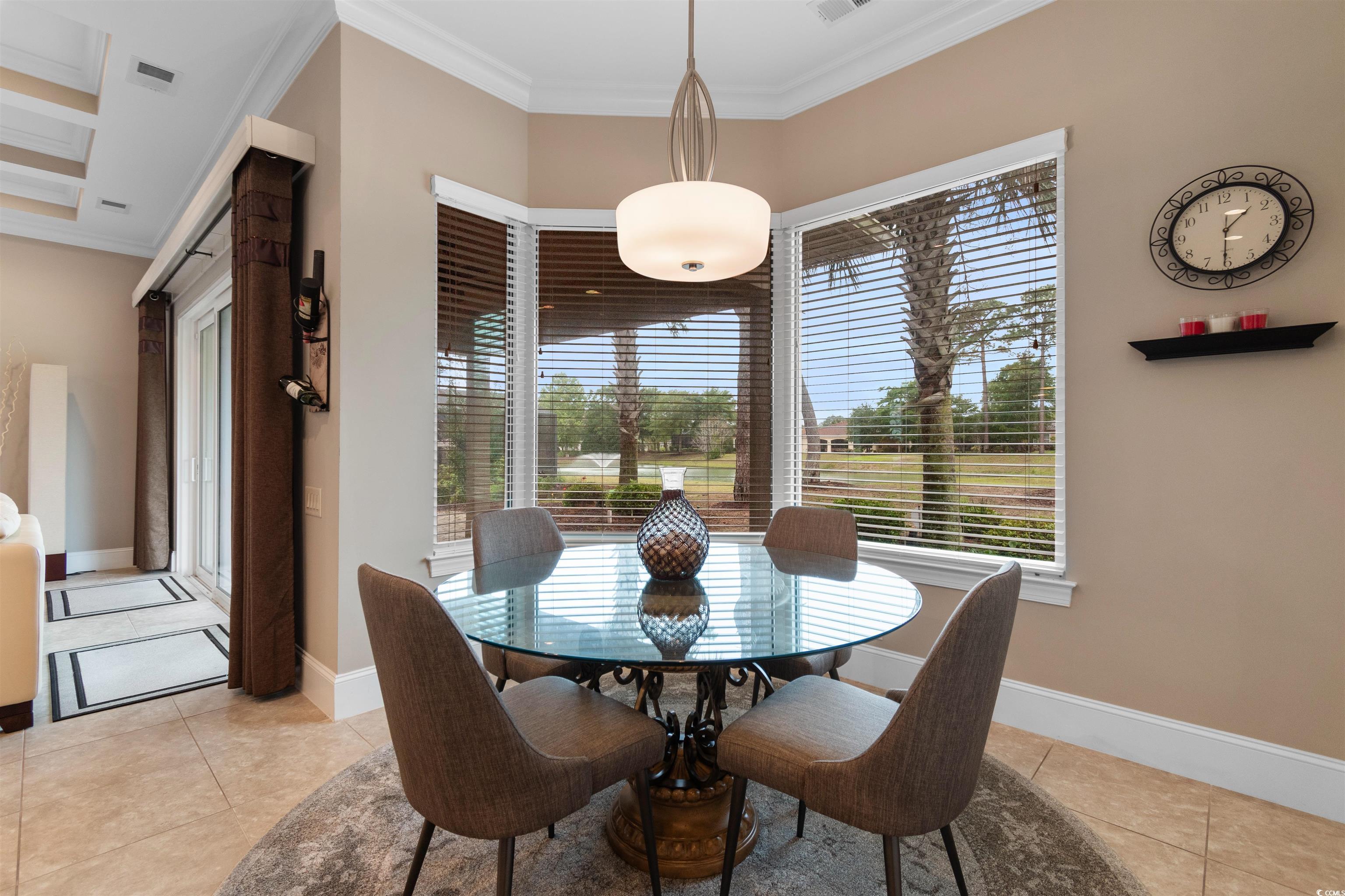 7253 Seville Drive Myrtle Beach, SC 29572 - Photo 14 of 39 Dining space featuring light tile patterned floors, crown molding, and baseboards