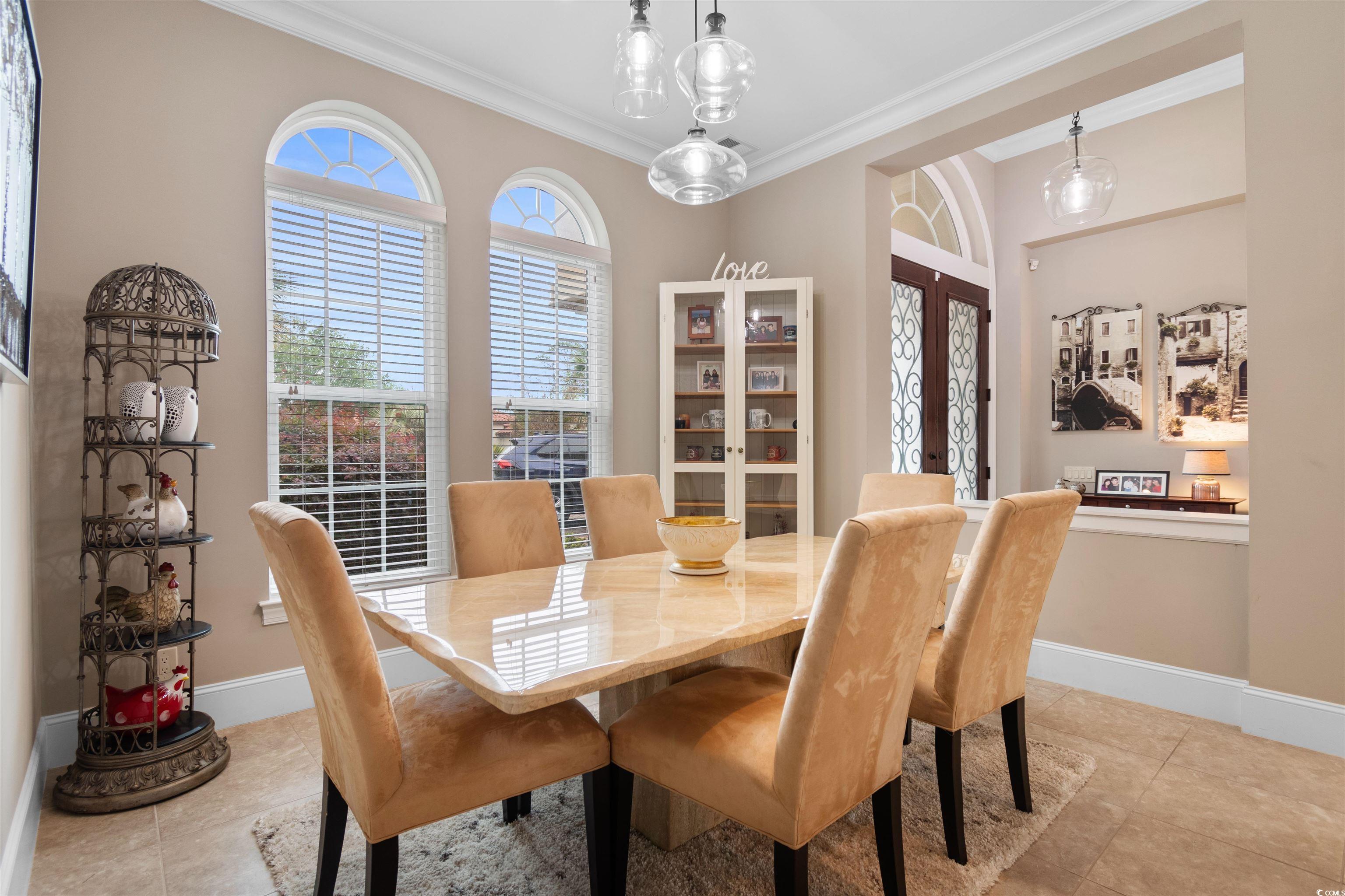 7253 Seville Drive Myrtle Beach, SC 29572 - Photo 16 of 39 Dining area with ornamental molding, tile patterned floors, baseboards, and french doors