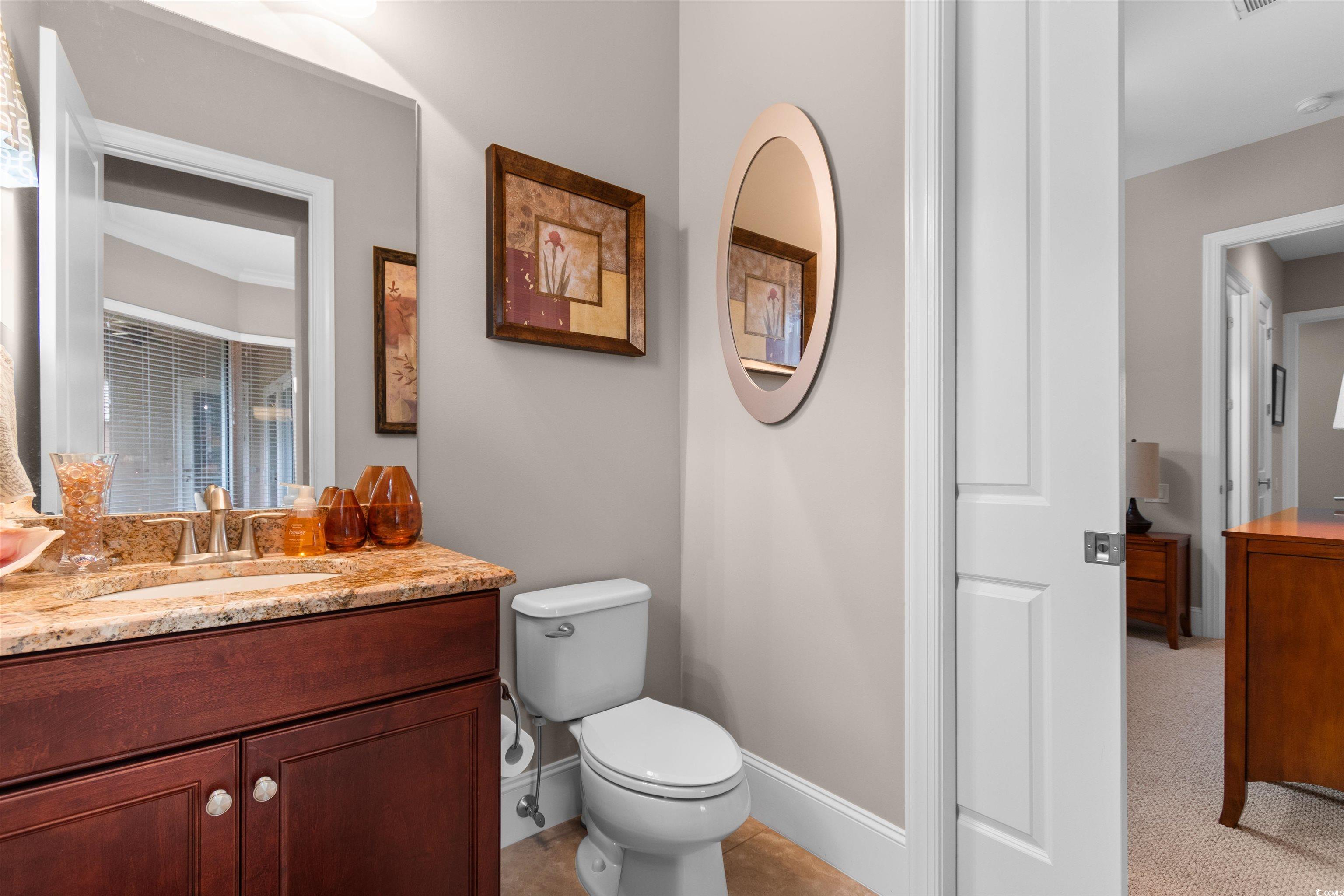7253 Seville Drive Myrtle Beach, SC 29572 - Photo 23 of 39 Bathroom with toilet, baseboards, and vanity