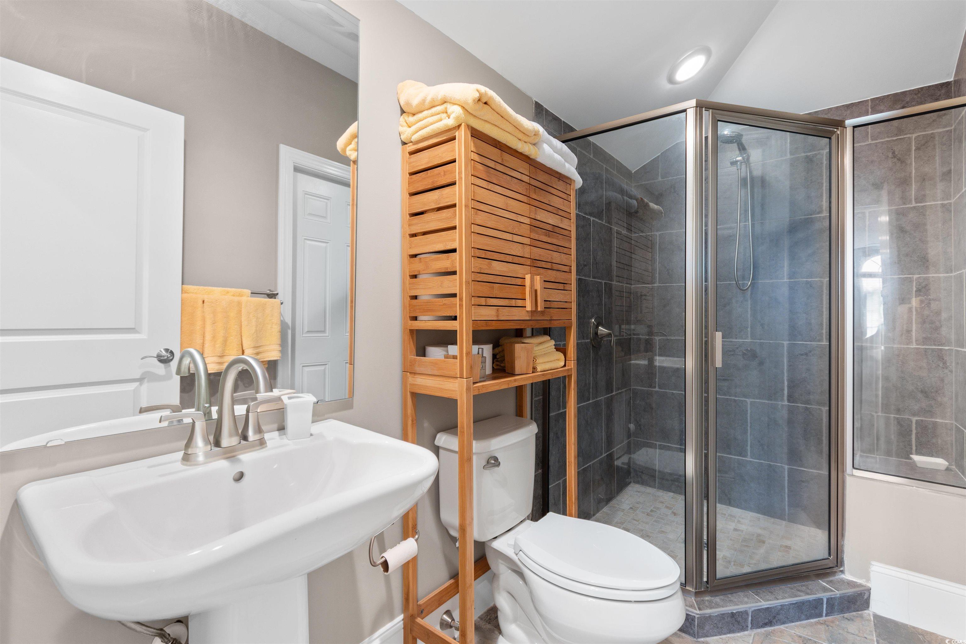7253 Seville Drive Myrtle Beach, SC 29572 - Photo 29 of 39 Bathroom with a sink, a shower stall, and toilet