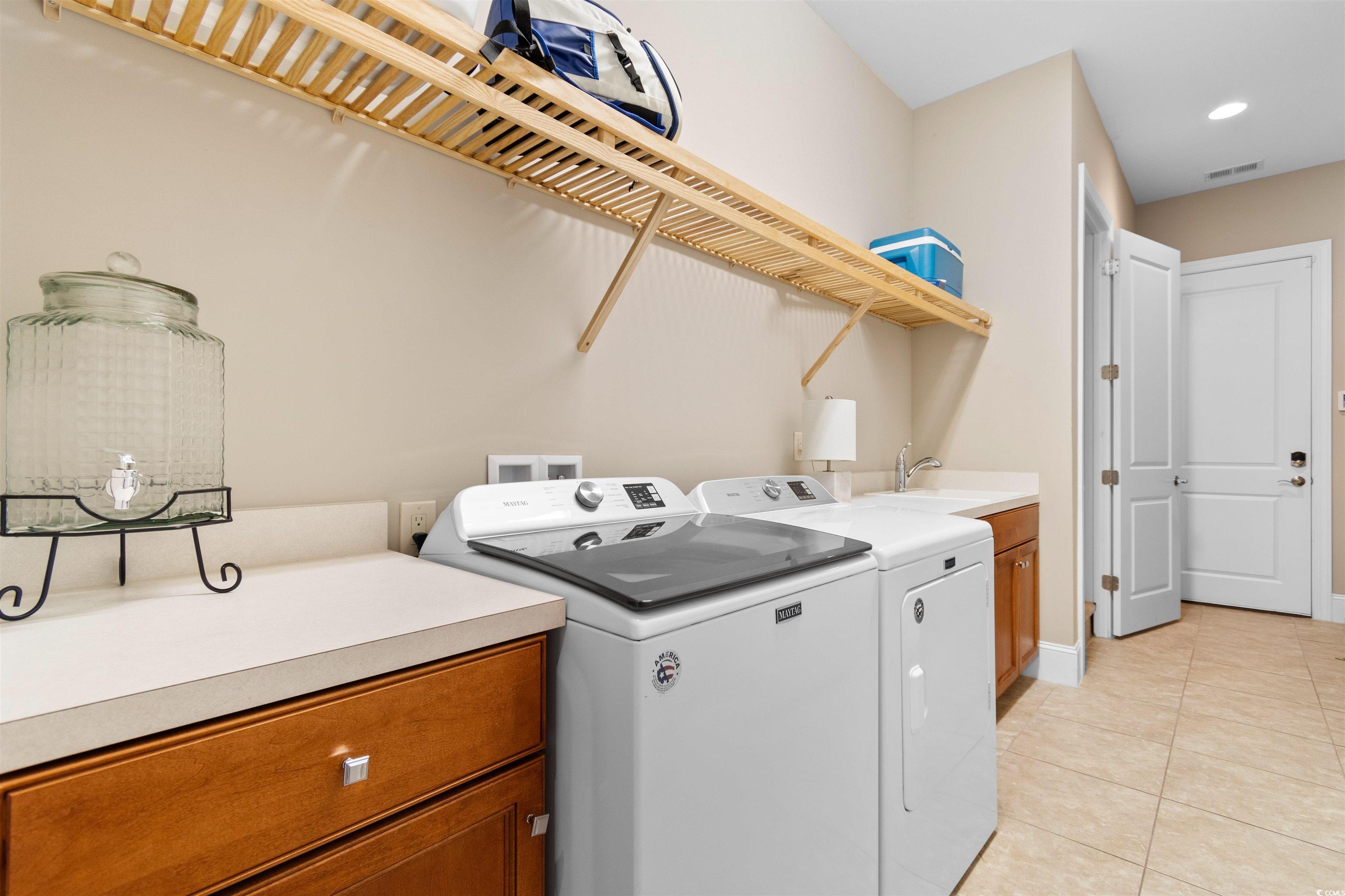 7253 Seville Drive Myrtle Beach, SC 29572 - Photo 30 of 39 Clothes washing area featuring washer and dryer, light tile patterned flooring, cabinet space, baseboards, and recessed lighting