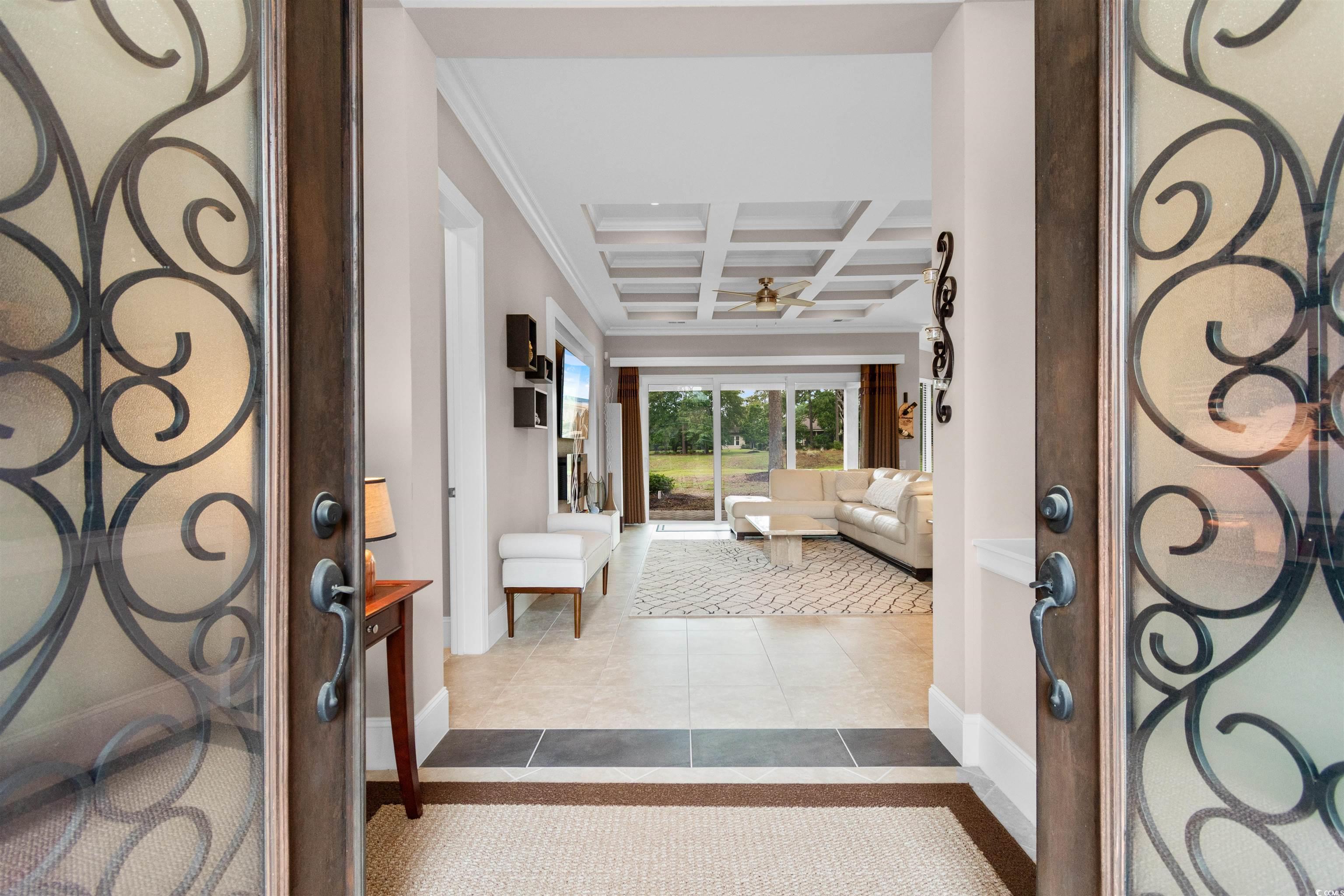 7253 Seville Drive Myrtle Beach, SC 29572 - Photo 3 of 39 Entrance foyer with baseboards, coffered ceiling, ceiling fan, beamed ceiling, and dark tile patterned floors
