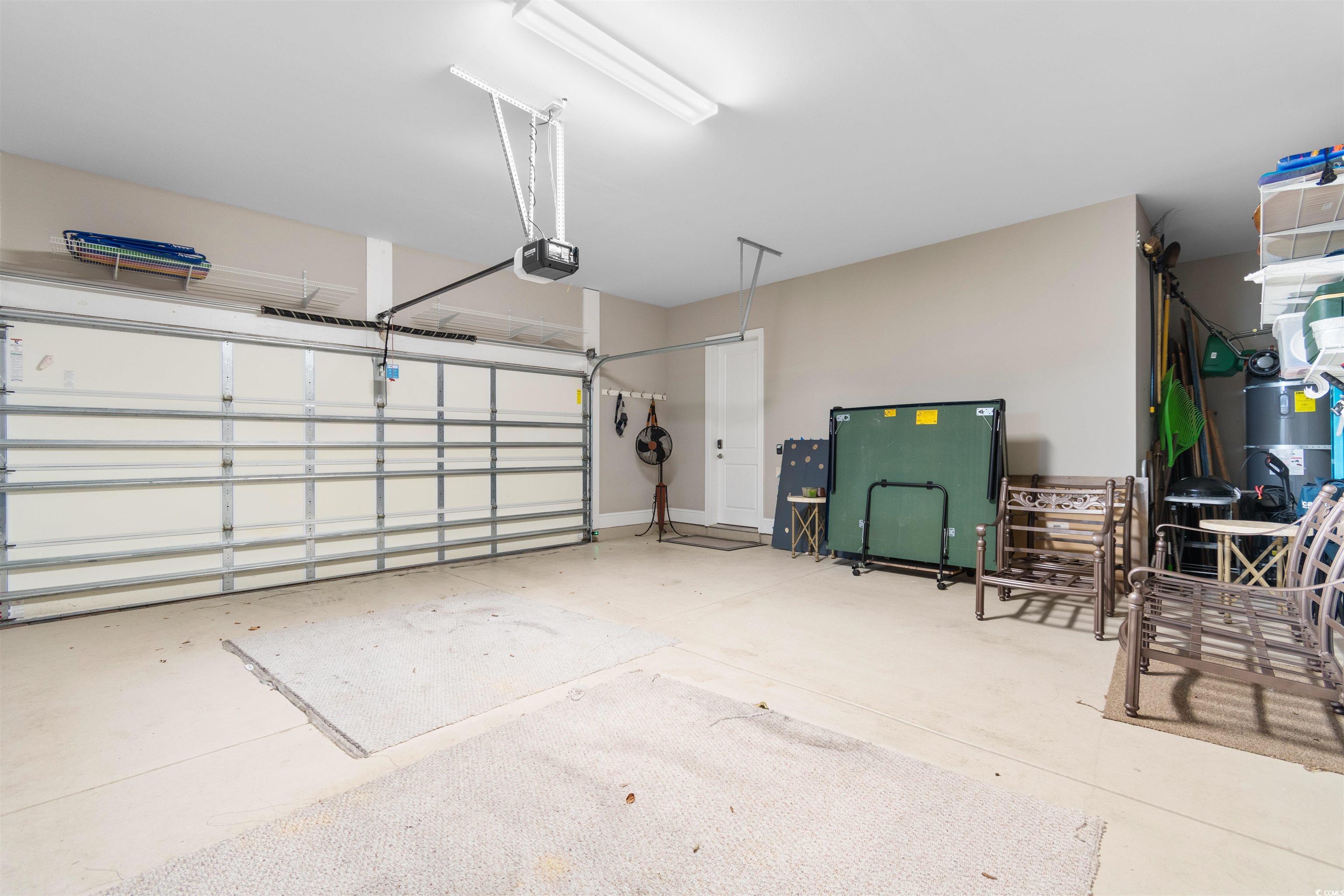7253 Seville Drive Myrtle Beach, SC 29572 - Photo 31 of 39 Garage with a garage door opener and secured water heater