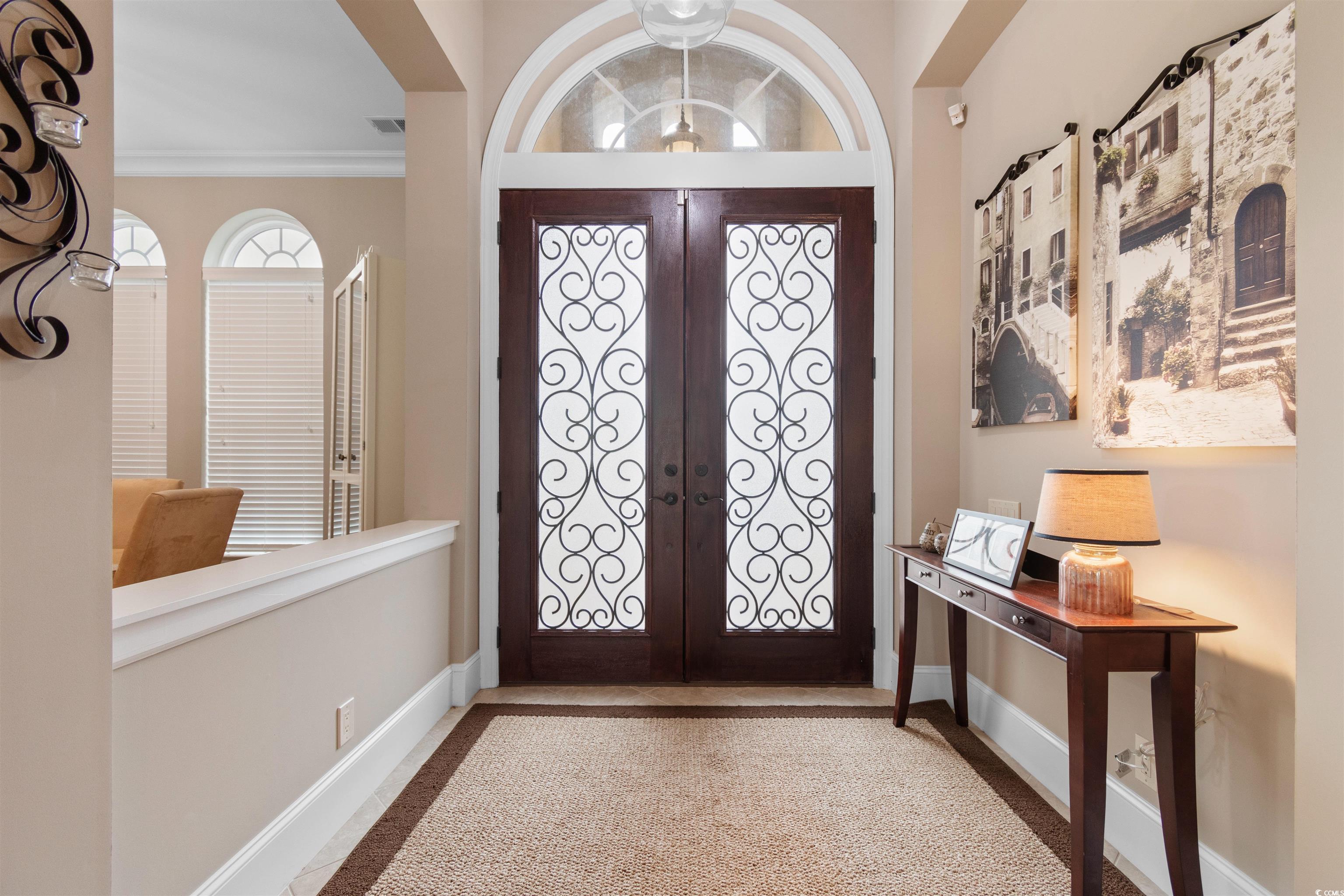 7253 Seville Drive Myrtle Beach, SC 29572 - Photo 4 of 39 Entrance foyer featuring baseboards, crown molding, and french doors