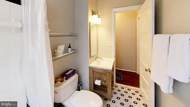 a bathroom with a toilet a sink and a shower