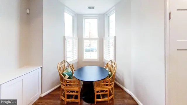 a dining room with furniture and wooden floor