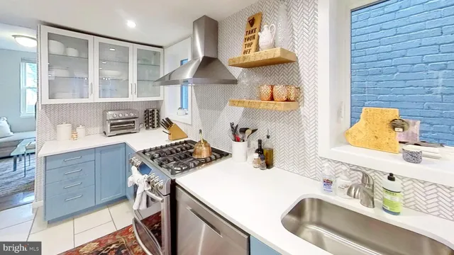 a kitchen with a sink stove and cabinets