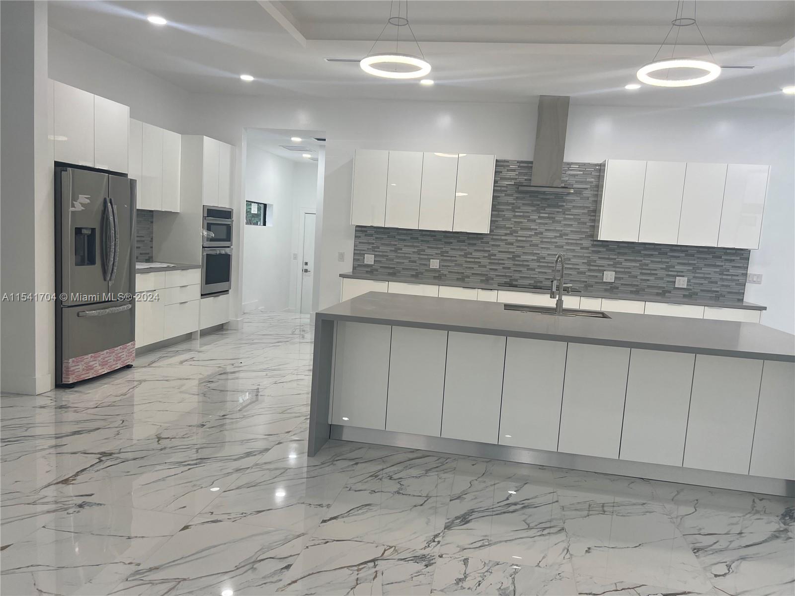 5455 Southwest 60th Court Miami, FL 33155 - Photo 12 of 68 a large bathroom with a large mirror vanity and shower