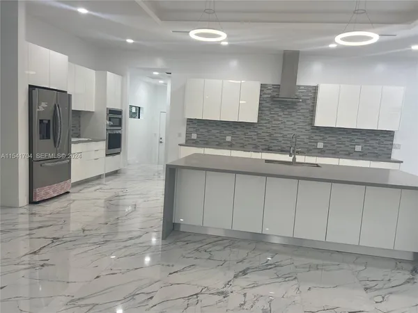 a kitchen with granite countertop a sink and a stove