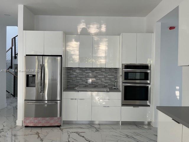 5455 Southwest 60th Court Miami, FL 33155 - Photo 14 of 68 a kitchen with a refrigerator and a stove