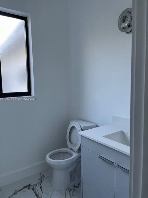 5455 Southwest 60th Court Miami, FL 33155 - Photo 21 of 68 a bathroom with a toilet sink and mirror