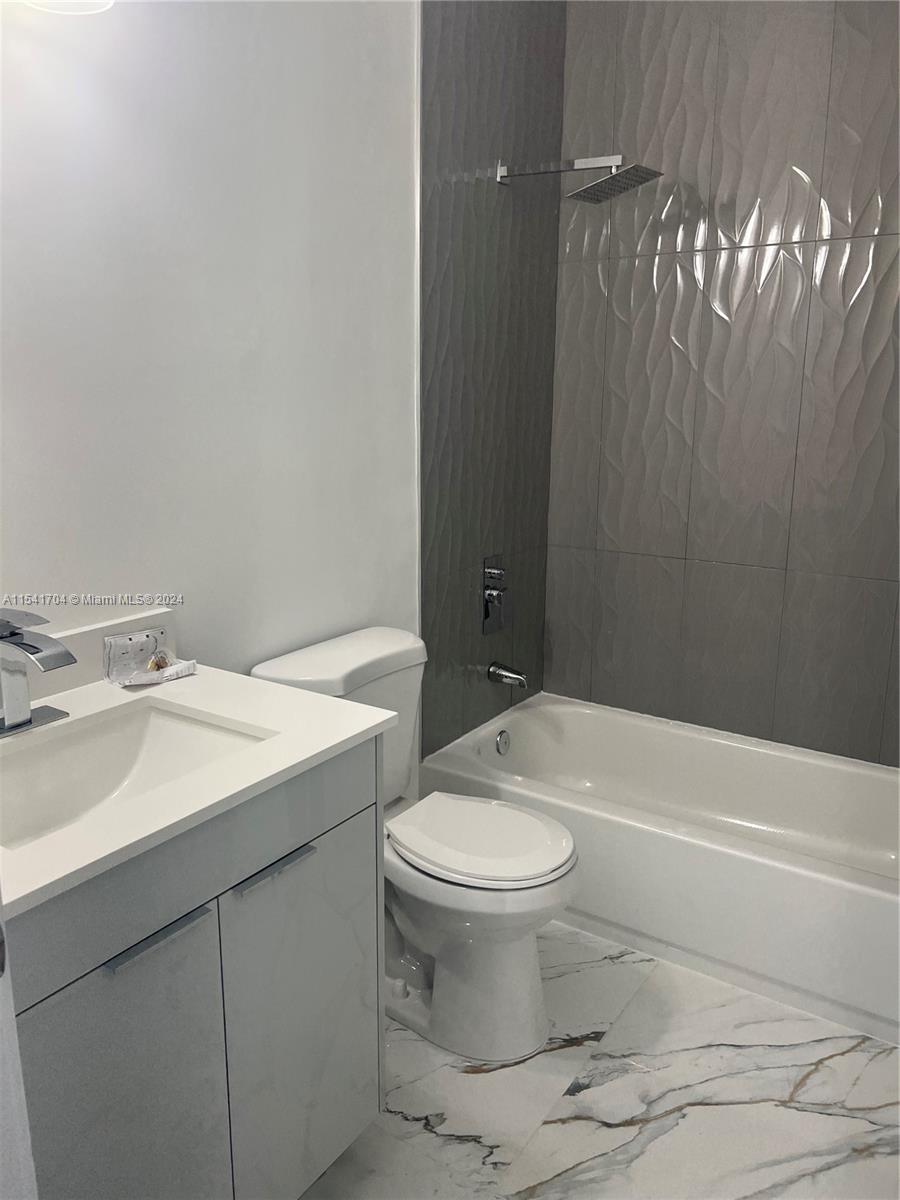 5455 Southwest 60th Court Miami, FL 33155 - Photo 30 of 68 a bathroom with a sink a toilet and shower