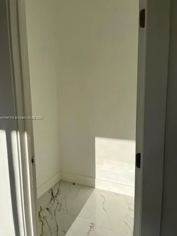a bathroom with a granite countertop sink and a window