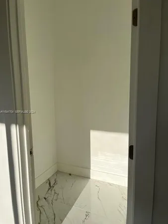 a bathroom with a granite countertop sink and a window
