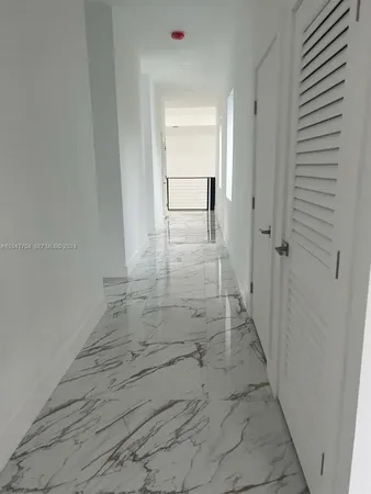 a bathroom with a bathtub and mirror