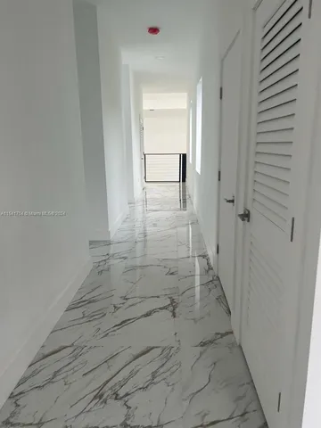 a bathroom with a bathtub and mirror