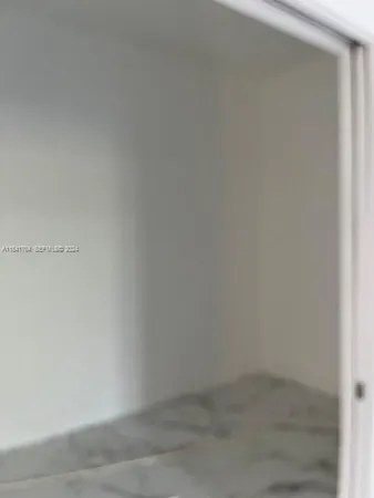 a view of a grassy field with trees