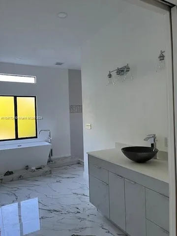 a view of a room with wooden floor and window