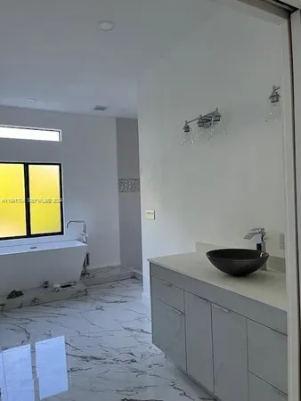 a view of a room with wooden floor and window