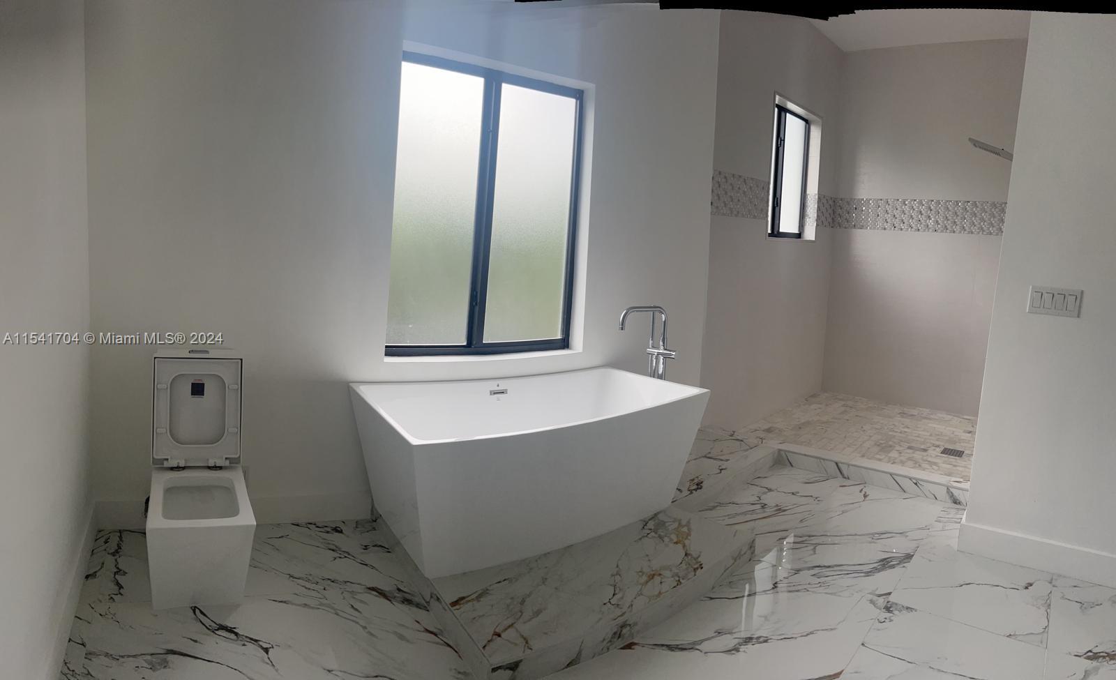 5455 Southwest 60th Court Miami, FL 33155 - Photo 52 of 68 a bathroom with a bathtub and mirror