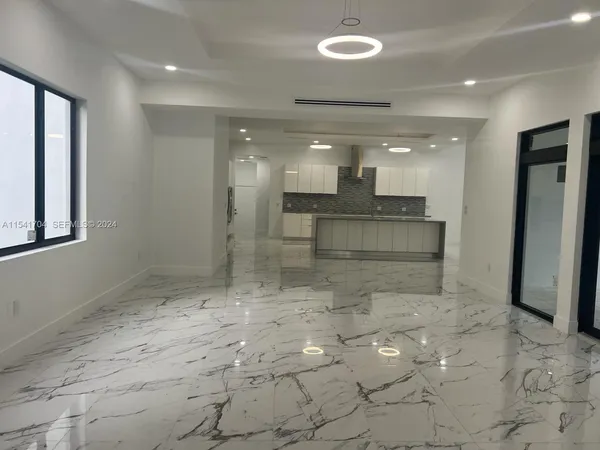 a large bathroom with a large mirror vanity and shower