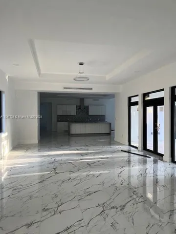 a kitchen with granite countertop white cabinets and stainless steel appliances