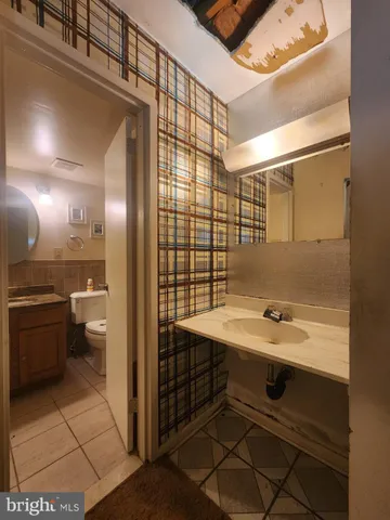 a bathroom with a sink a toilet and a shower